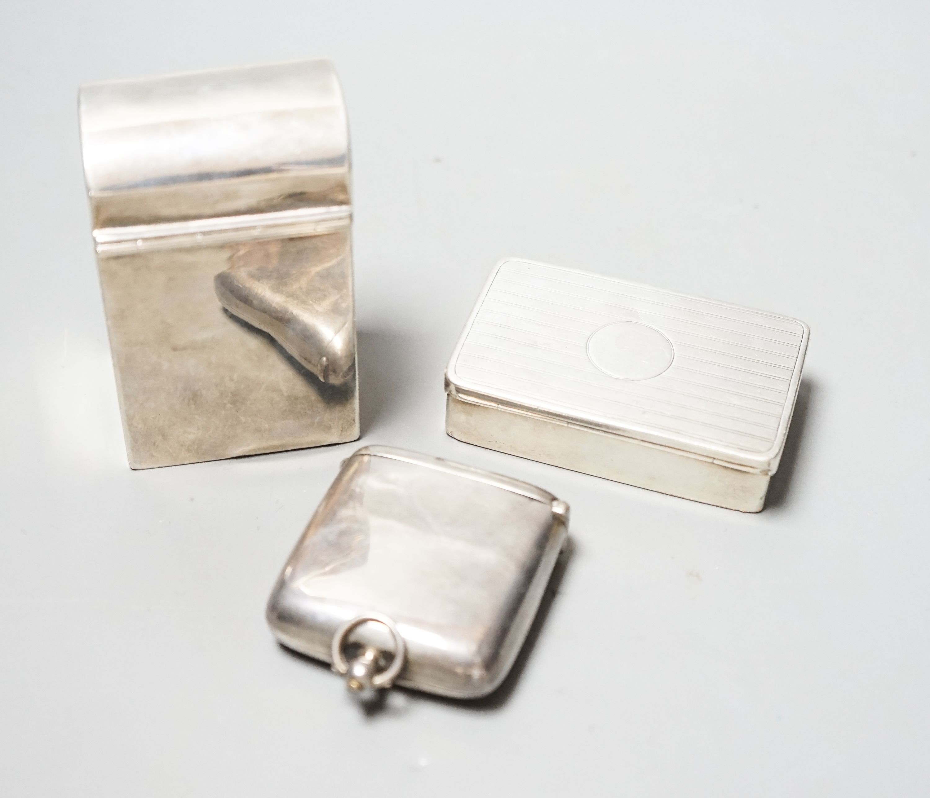 A late Victorian silver playing card box, Chester, 1900, 85mm, a similar snuff and a silver combination vesta case and sovereign/half sovereign case.